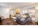 Open-concept living room featuring a gray sofa, patterned rug, and seamless flow into the kitchen at 2195 Edison Ne Ave, Atlanta, GA 30305