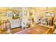 Open-concept living space with hardwood floors, area rug, and seamless flow between living and dining areas at 2195 Edison Ne Ave, Atlanta, GA 30305