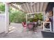 Spacious backyard patio with overhead lights, dining furniture, and privacy from mature landscaping at 2195 Edison Ne Ave, Atlanta, GA 30305