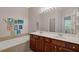 Bathroom with dual vanities, dark wood cabinets, and a large mirror with vanity lighting at 2329 Marion Walk Se Dr # 5, Atlanta, GA 30339