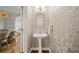 Stylish powder room featuring elegant wallpaper and a pedestal sink at 2329 Marion Walk Se Dr # 5, Atlanta, GA 30339