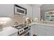 Modern kitchen with stainless steel appliances, white cabinets, and decorative tile backsplash at 2329 Marion Walk Se Dr # 5, Atlanta, GA 30339