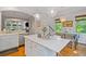 Bright kitchen features a marble island, hardwood floors, and modern pendant lighting at 2329 Marion Walk Se Dr # 5, Atlanta, GA 30339