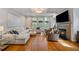 Open-concept living room features hardwood floors, fireplace, and large windows at 2329 Marion Walk Se Dr # 5, Atlanta, GA 30339