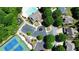 Aerial view of the community pool, tennis courts, parking lot, and surrounding homes at 621 Oakbourne Way, Woodstock, GA 30188