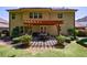 Exterior of home showcasing a covered patio with outdoor seating, lush landscaping, and a well-manicured lawn at 621 Oakbourne Way, Woodstock, GA 30188