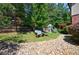 Backyard with playset, stone path, and wooded perimeter at 621 Oakbourne Way, Woodstock, GA 30188