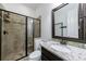 Bathroom featuring granite countertop vanity and walk-in shower with tiled walls, providing a clean and stylish space at 621 Oakbourne Way, Woodstock, GA 30188