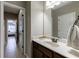 Bathroom featuring a vanity with single sink, a mirror, and tile flooring at 621 Oakbourne Way, Woodstock, GA 30188