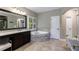 Bright bathroom featuring a corner bathtub, a frameless shower, and double sinks at 621 Oakbourne Way, Woodstock, GA 30188