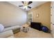 Bedroom featuring neutral carpet, ceiling fan, lounger, and a small table for versatile use and comfort at 621 Oakbourne Way, Woodstock, GA 30188