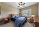 Bright bedroom with a large window, comfortable chair, and side table at 621 Oakbourne Way, Woodstock, GA 30188