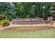 Stone neighborhood sign reading 'Woodstock Knoll' with manicured landscaping and green grass at 621 Oakbourne Way, Woodstock, GA 30188