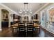 Dining room with dark wood cabinets and a large wooden table with seating for eight at 621 Oakbourne Way, Woodstock, GA 30188