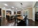 Dining area showcasing a wooden table, decorative lighting, and access to the outdoors at 621 Oakbourne Way, Woodstock, GA 30188