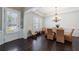 Well-lit dining room featuring a glass-top table, and access to a side entry door at 621 Oakbourne Way, Woodstock, GA 30188