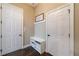 Entryway featuring two doors, a bench with shoe storage, and wall hooks at 621 Oakbourne Way, Woodstock, GA 30188