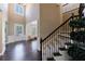 Grand foyer with hardwood floors, staircase, and natural light, providing an inviting entrance at 621 Oakbourne Way, Woodstock, GA 30188