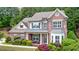 Charming two-story brick home with a covered front porch and beautifully landscaped yard at 621 Oakbourne Way, Woodstock, GA 30188