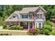 Front elevation of a well maintained two-story brick home with mature landscaping and classic architectural details at 621 Oakbourne Way, Woodstock, GA 30188