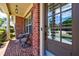 Charming front porch with brick flooring, comfortable seating, and a welcoming entrance to the home at 621 Oakbourne Way, Woodstock, GA 30188