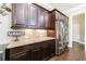 Kitchen area featuring stainless steel appliances, wood cabinetry, and granite countertops at 621 Oakbourne Way, Woodstock, GA 30188