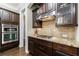 Close-up of kitchen area with built-in microwave and oven over gas cooktop at 621 Oakbourne Way, Woodstock, GA 30188