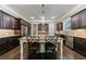 Spacious kitchen island with seating, dark wood cabinets and stainless appliances at 621 Oakbourne Way, Woodstock, GA 30188