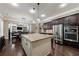 Spacious kitchen boasts an island, stainless steel appliances, and dark wood cabinets at 621 Oakbourne Way, Woodstock, GA 30188