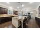 Open kitchen with island, stainless steel appliances, and view to living room at 621 Oakbourne Way, Woodstock, GA 30188