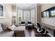 Cozy living area with a bay window, TV, and dark wood floors, ideal for relaxing and entertaining guests at 621 Oakbourne Way, Woodstock, GA 30188