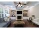 Elegant living room featuring a fireplace, built-in shelves, and hardwood floors at 621 Oakbourne Way, Woodstock, GA 30188