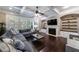 Open concept living area with fireplace, built-ins, and large windows with views of the private backyard at 621 Oakbourne Way, Woodstock, GA 30188
