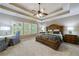 Main bedroom features tray ceilings, large windows, and plush carpet flooring at 621 Oakbourne Way, Woodstock, GA 30188