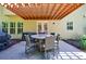 Covered patio featuring a round table with seating, a grill, and an inviting outdoor dining space at 621 Oakbourne Way, Woodstock, GA 30188