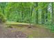 This wooded backyard is partially cleared and fenced in at 1515 Barrier Rd, Marietta, GA 30066