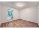 This bedroom features wood floors, a window with wooded views and neutral paint throughout at 1515 Barrier Rd, Marietta, GA 30066