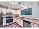 Bright kitchen featuring stainless steel appliances, granite countertops, and wood-look flooring at 1515 Barrier Rd, Marietta, GA 30066