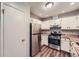 A stainless steel refrigerator and range complement the kitchen with granite countertops at 1515 Barrier Rd, Marietta, GA 30066