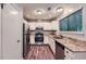A well-lit kitchen featuring stainless steel appliances, granite counters and painted cabinets at 1515 Barrier Rd, Marietta, GA 30066