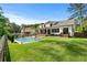 Well-manicured backyard features a pool, grassy lawn, and a white two-story home at 2373 Sagamore Hills Dr, Decatur, GA 30033