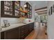 A bar area including counter space, a sink and dark cabinets with wine and glassware storage at 2373 Sagamore Hills Dr, Decatur, GA 30033