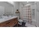 Bathroom with modern vanity, tile floor, and shower with neutral curtain at 2373 Sagamore Hills Dr, Decatur, GA 30033