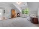 A bonus room area featuring carpet floors, a window, an arm chair, and a desk at 2373 Sagamore Hills Dr, Decatur, GA 30033