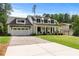Charming two-story home with a symmetrical facade, inviting front porch, and a brick driveway at 2373 Sagamore Hills Dr, Decatur, GA 30033