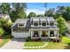 Beautiful home with a white exterior, metal roof accents, and a welcoming front porch at 2373 Sagamore Hills Dr, Decatur, GA 30033