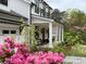 Inviting front porch with chairs, beautiful landscaping, and a charming white exterior at 2373 Sagamore Hills Dr, Decatur, GA 30033