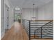 A bright hallway with hardwood floors, white shiplap walls, metal railing, and modern light fixture at 2373 Sagamore Hills Dr, Decatur, GA 30033