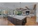 A large kitchen island with seating, sink, and dining area open to the living room with wooden beams at 2373 Sagamore Hills Dr, Decatur, GA 30033