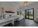A spacious mud room with white cabinets, counter space, black slate floors, and direct access to the backyard at 2373 Sagamore Hills Dr, Decatur, GA 30033